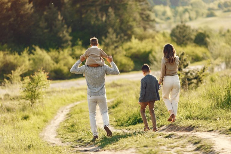 What is Parenting - modern family walking together, parents guiding children outdoors